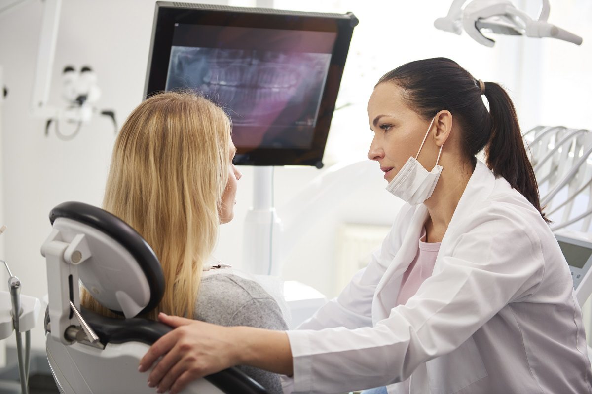 dentist-talking-worried-woman-during-dental-checkup.jpg