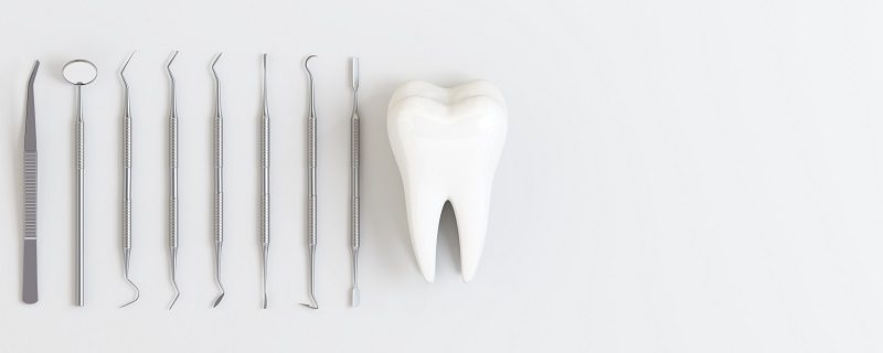 dentist-tools-with-teeth-white-background.jpg